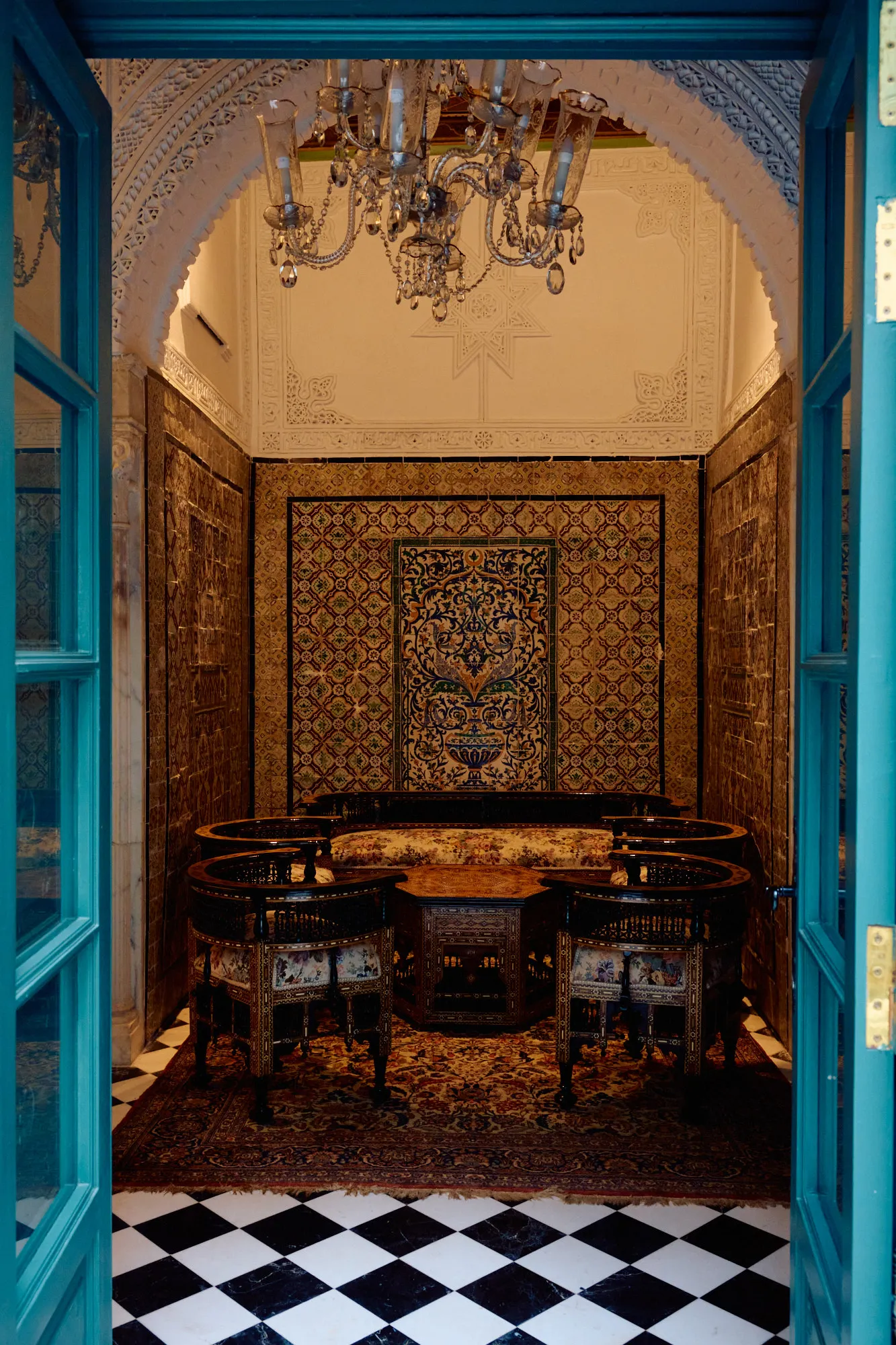 Painted blue doors standing open onto a tiled room.