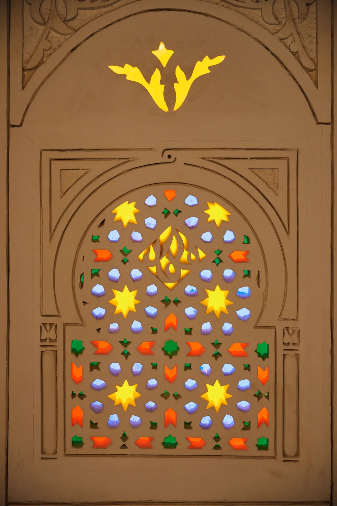 A star-shaped stained-glass window in coloured glass.