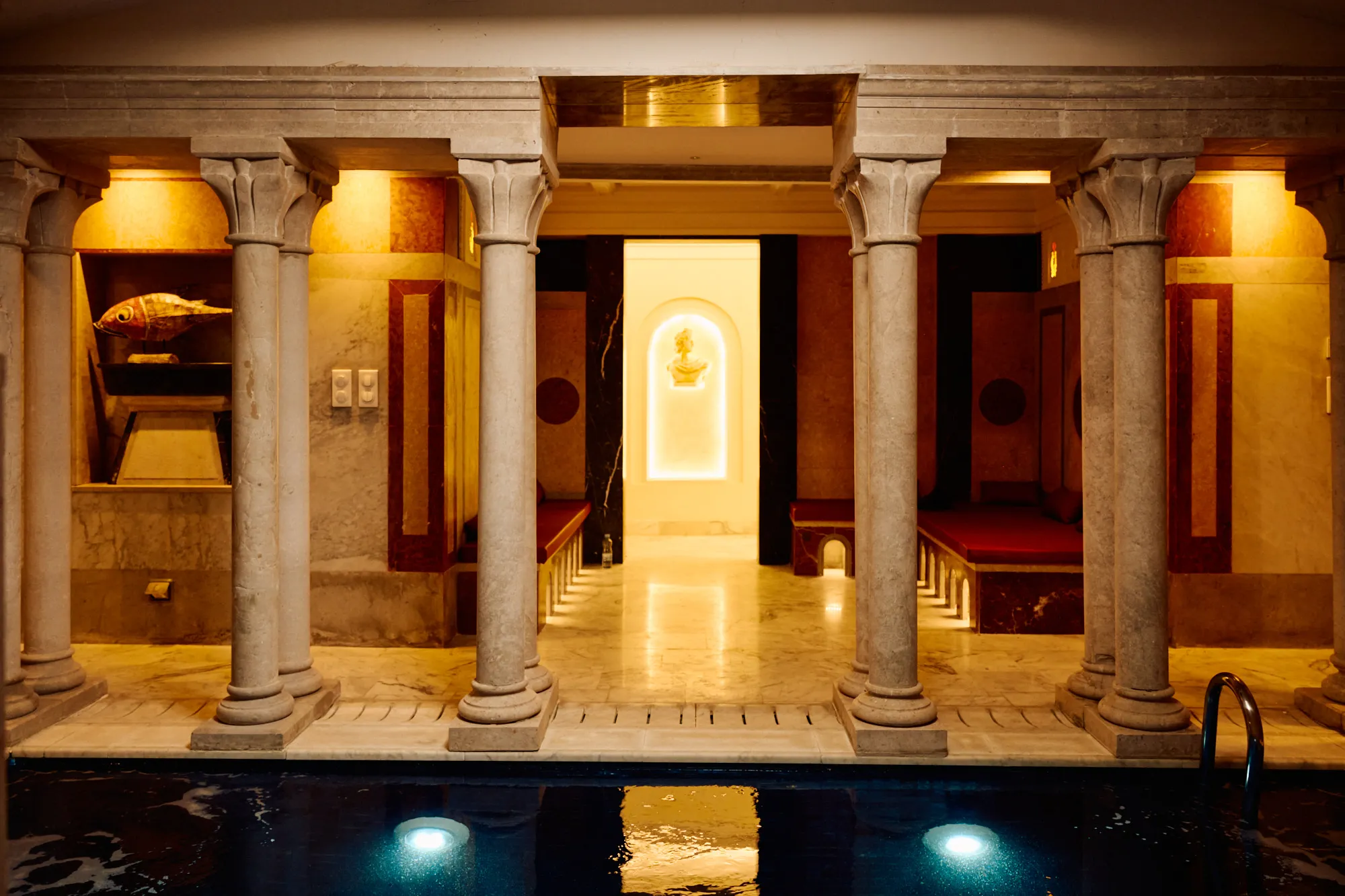A marble colonnade running the length of the covered pool.