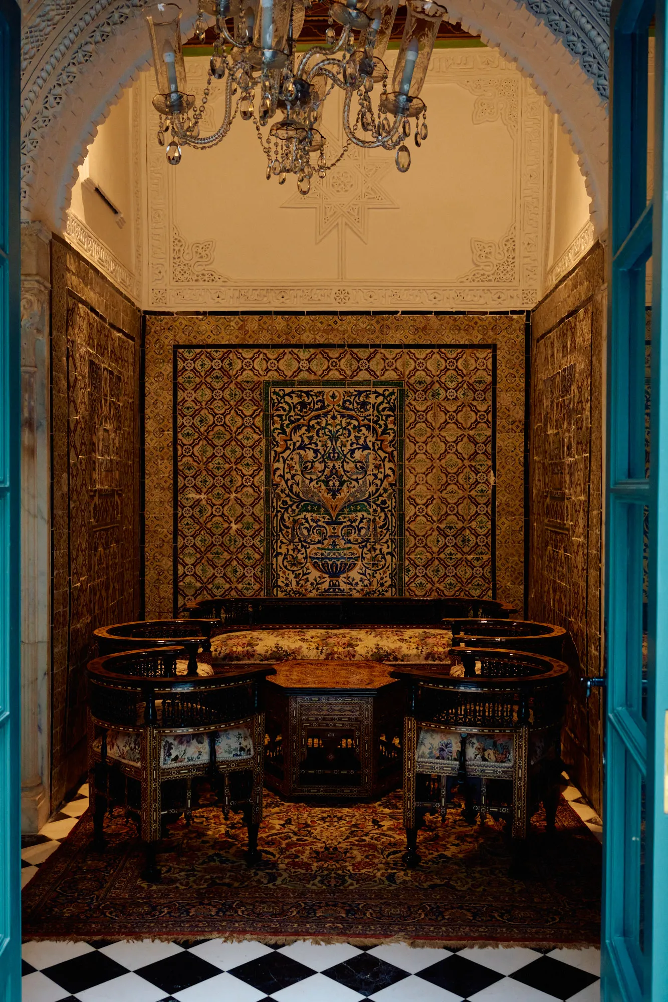 Painted blue doors standing open onto a tiled dining room.